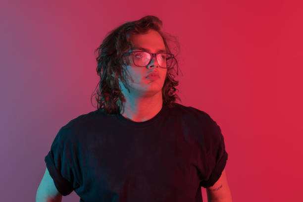 istock Portrait of smiling young man on neon colored 1169525105