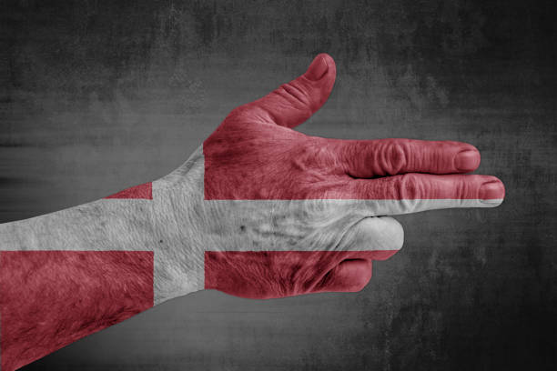 istock Denmark flag painted on male hand like a gun 1169525187