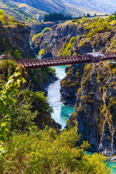 Extreme Sports - bungee jumping into the abyss upside down. New Zealand. River and bridge Kawarau between Queenstown and the town of Cromwell. The concept of extreme, active and photo tourism