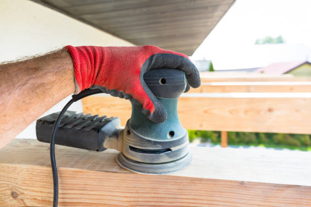 istock The carpenter manually polishes the beam 1169526367