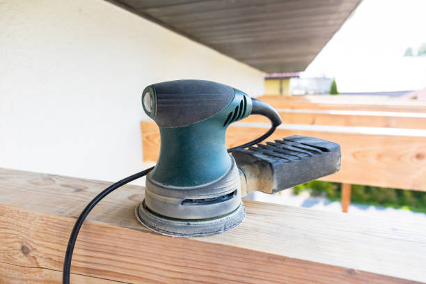 Electric grinder placed on wooden beams