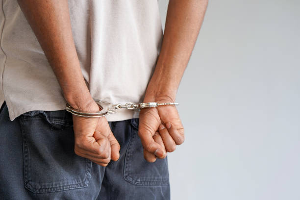 istock Arrested african man with handcuffs 1169526574