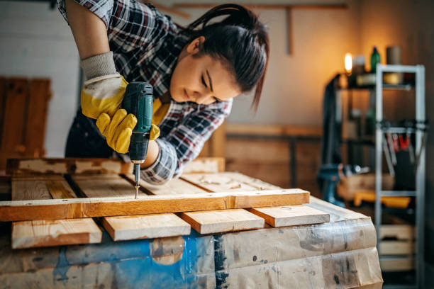 istock Woman screwing with drill 1169527682
