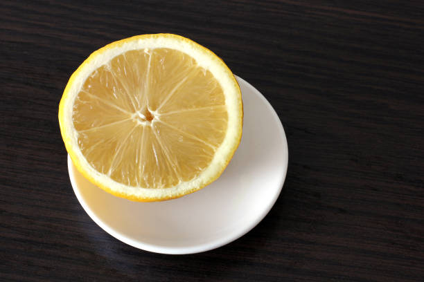 istock Half a lemon on a wooden background 1169527702