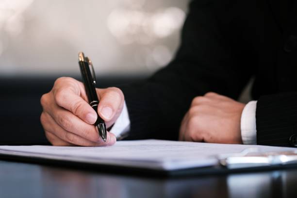 istock Businessman analyzing investment charts and pressing calculator buttons over documents. Accounting Concept. 1169527899