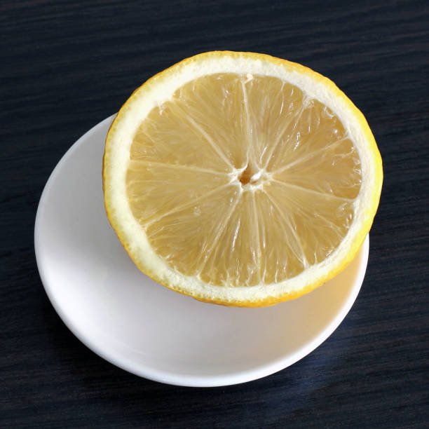 istock Half a lemon on a wooden background 1169528484