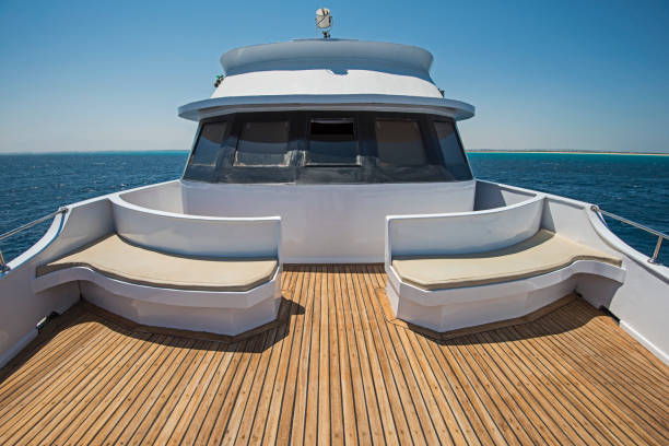 View over the bow over a large motor yacht View over the bow of a large luxury motor yacht on tropical open ocean with bridge cabin boat deck stock pictures, royalty-free photos & images