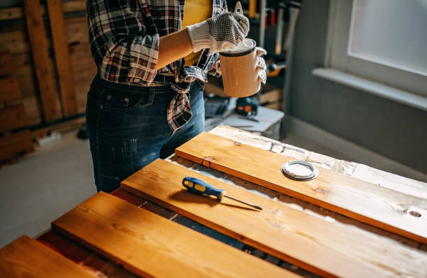 istock Woman opening paint can 1169529336
