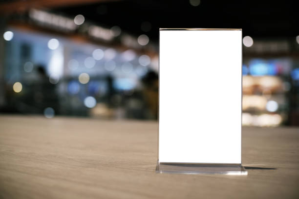 istock Mock up Menu frame standing on wood table in Bar restaurant cafe. space for text 1169530450