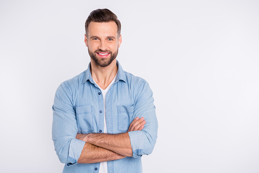 Portrait of his he nice-looking attractive masculine cheerful cheery, bearded healthy content guy folded arms isolated over light white pastel background