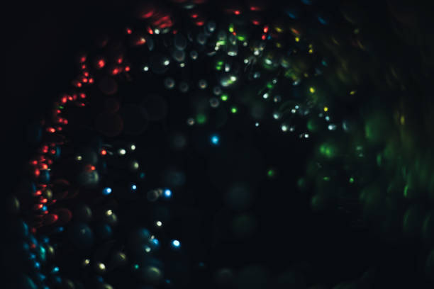 istock Beautiful multi colored light bokeh on a black background. 1169532497