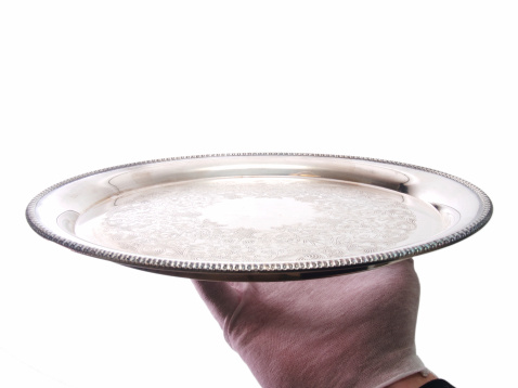Close up of a empty silver platter on a kitchen table