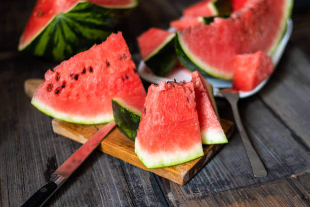 istock Slices of watermelon on old wooden rustic table 1169536435