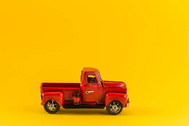 istock Red toy truck on bright yellow background 1169536506