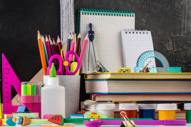 istock School stationery on a table in front of blackboard 1169536565