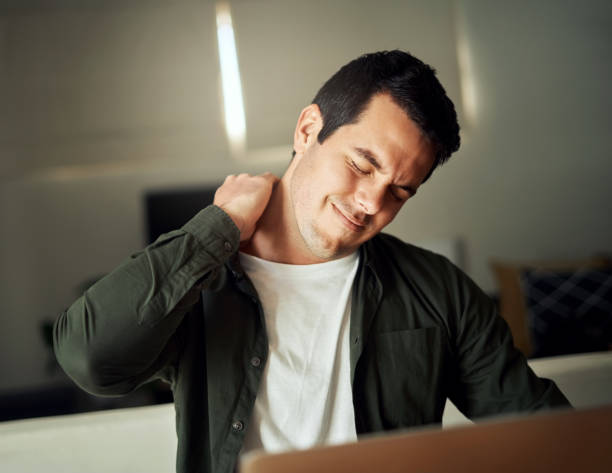 istock Man touching his neck with hand suffering from pain 1169537453