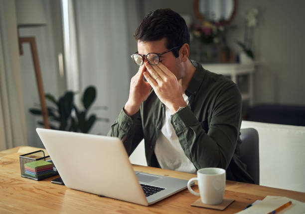 istock Man having stressful time working on laptop at home 1169537905
