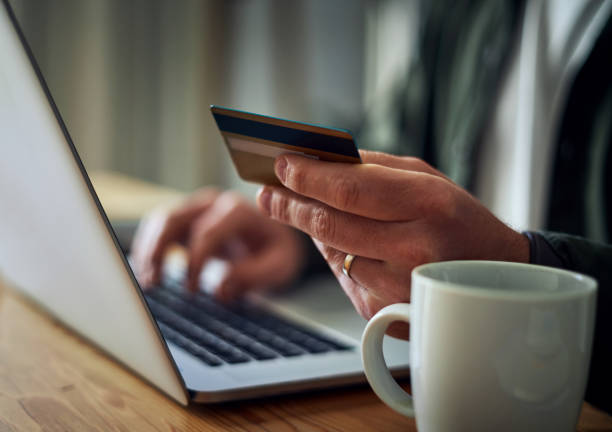 istock Man buying online with a credit card 1169539280