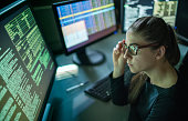 Woman surrounded by monitors