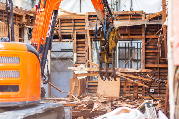 la pelle rétrocaveuse est démolir la vieille maison pour faire la construction de nouvelle maison. - demolishing photos et images de collection