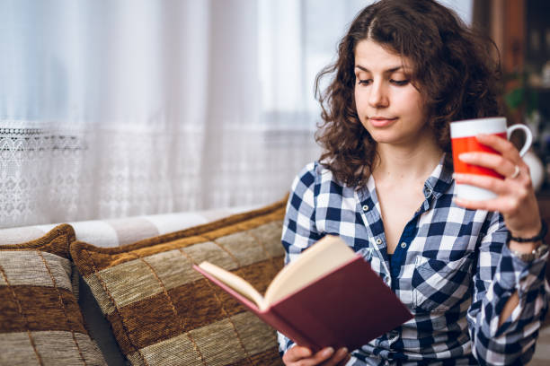 istock Reading book with cup of coffee 1169541774