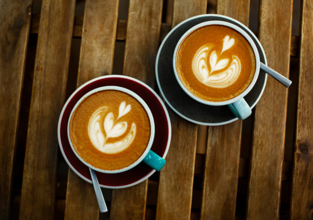istock Two cup of coffee on wooden background 1169543130
