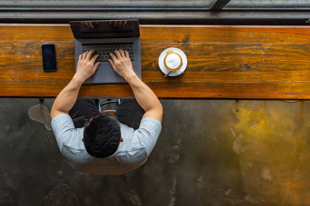 istock High angle view of Asian millennial working on laptop 1169543201