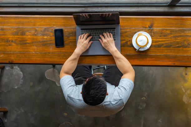istock Isolated Asian freelancer working on laptop at rustic coffeeshop 1169544457