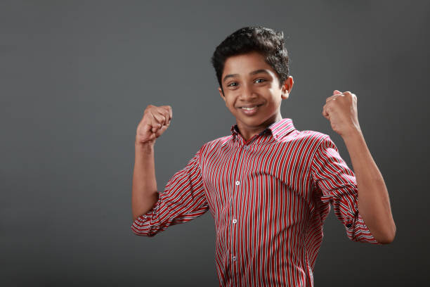 Portrait of a happy boy shows winning expression