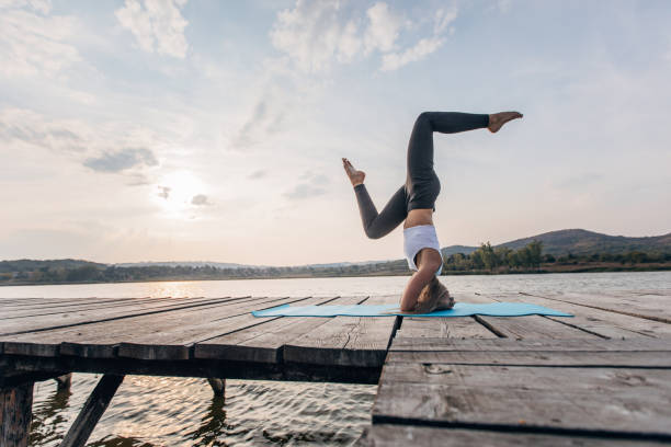 istock Yoga exercise by the river in sunset 1169546329