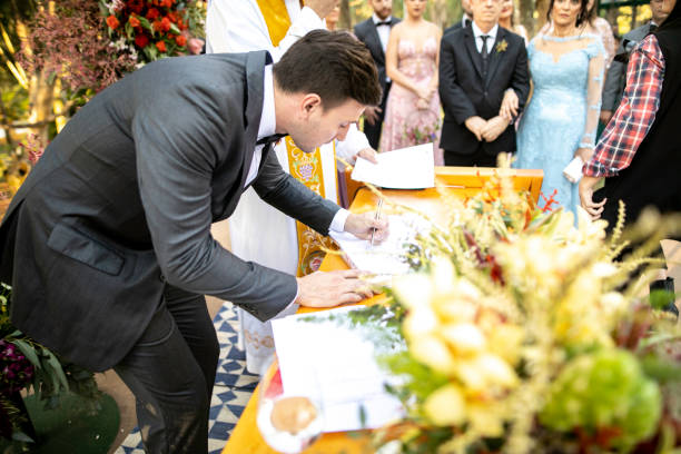 istock Groomsman signing wedding book 1169550355