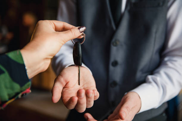 Valet Parking at a Hotel A close up of an unrecognisable woman handing her car keys over to the hotel concierge. porter photos stock pictures, royalty-free photos & images