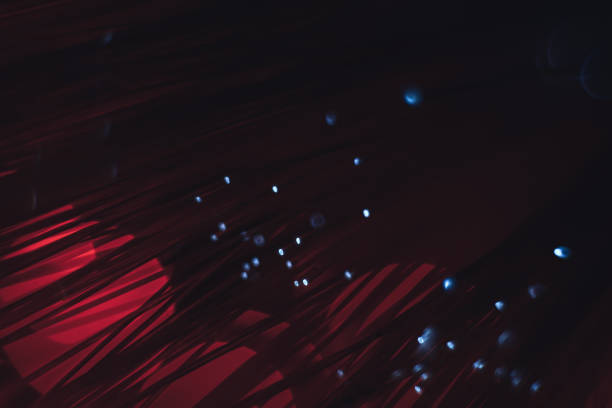istock Beautiful abstract optical fiber line on a red bokeh background. 1169552083