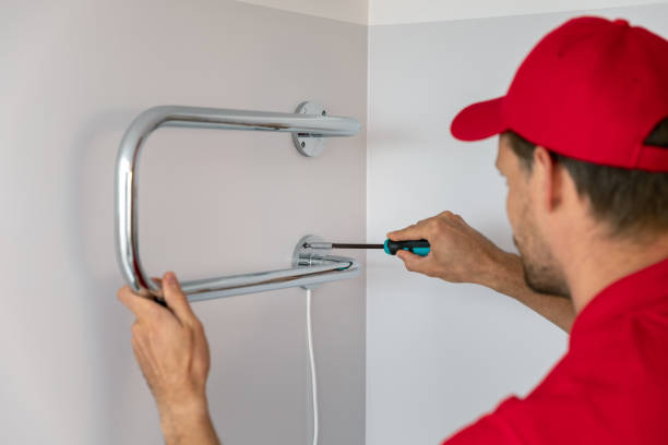 istock worker installing electric towel dryer on the bathroom wall 1169552412