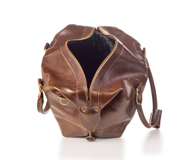istock broun skin luggage bag open, isolated 1169554316