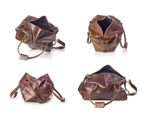 istock broun skin luggage bag open, isolated 1169554318