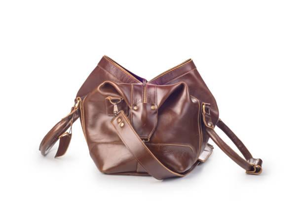 istock broun skin luggage bag open, isolated 1169554342