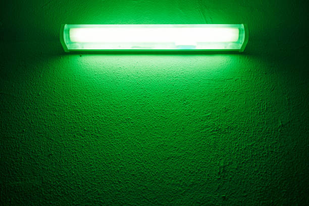 public lamp with green light on a dark background