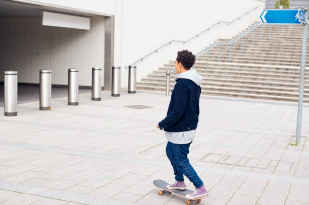 istock Young Woman Riding On Skateboard Through City Underpass 1169562443