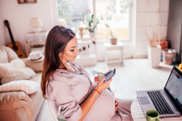 istock Pregnant woman using mobile phone 1169563865