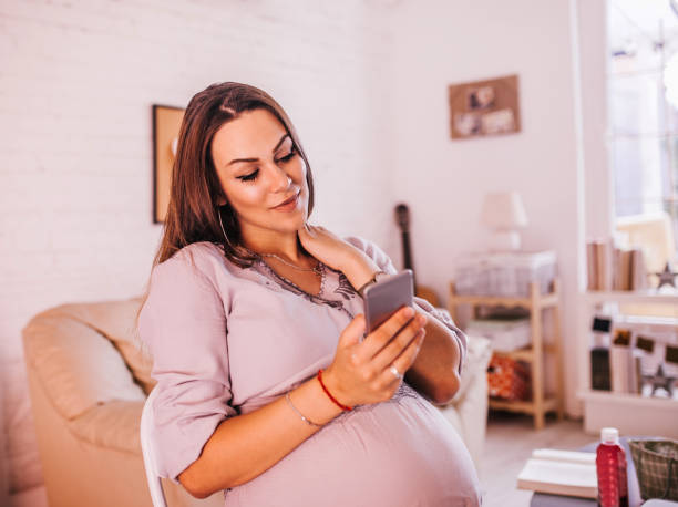 istock Pregnant woman using mobile phone 1169563924