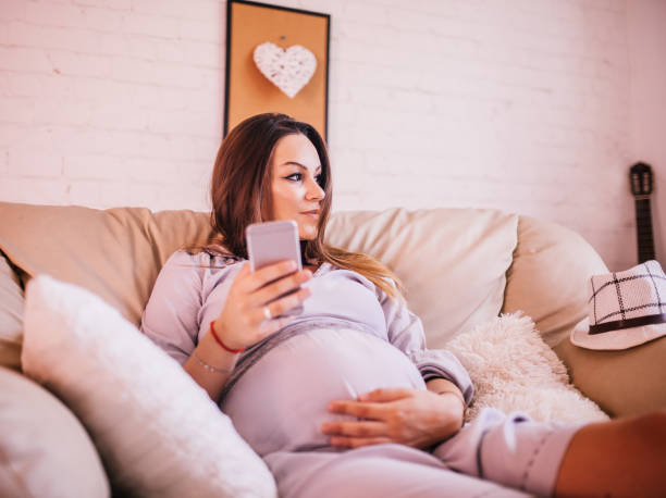 istock Pregnant woman using mobile phone 1169564578