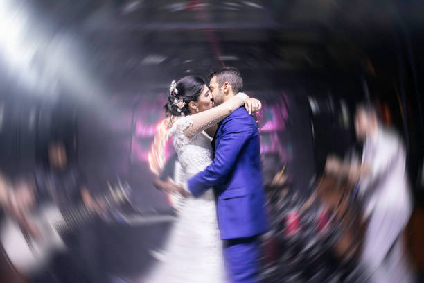 Bride and groom kissing in the dance floog Bride and groom kissing in the dance floog wedding ceremony formalwear people clothing stock pictures, royalty-free photos & images