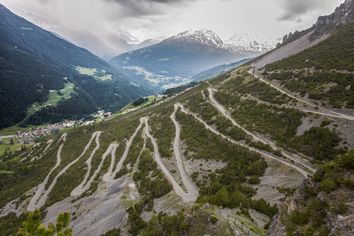 U-shape curved road towards Towers of Fraele, a touristic attraction in North Valtellina, Italy.