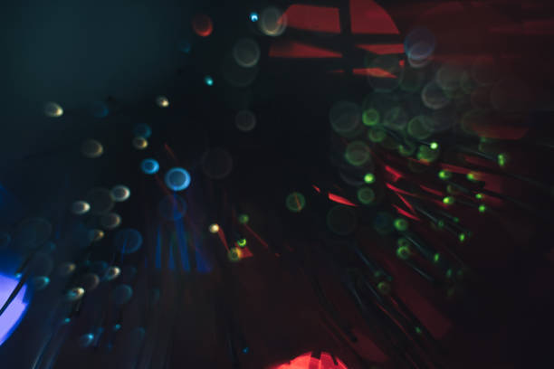 istock Beautiful multi-colored abstract optical fiber line on a red bokeh background. 1169568434
