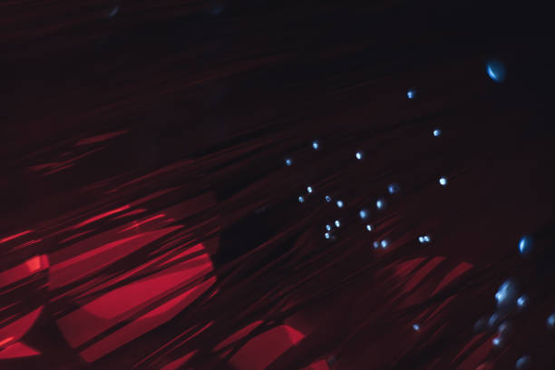 istock Beautiful abstract optical fiber line on a red bokeh background. 1169570771