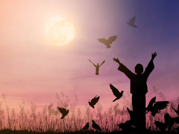 istock woman praying and free bird flying 1169572015
