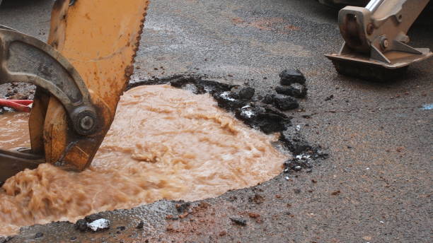 istock Water pipe break, leaking from hole in a road 1169573004