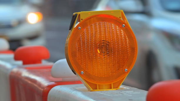istock orange construction boards and flashing lights 1169573030