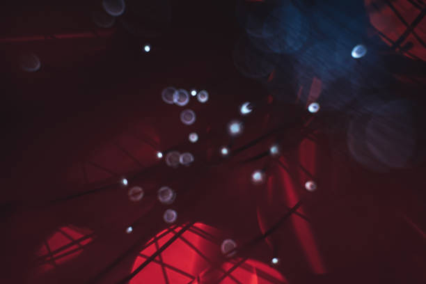 istock Beautiful abstract optical fiber line on a red bokeh background. 1169574179